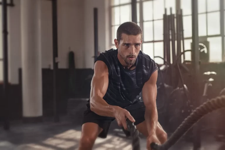 man doing crossfit exercise with rope utc