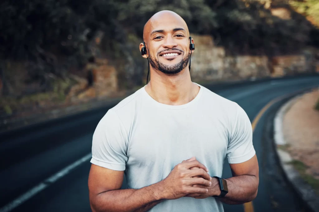 shot of a sporty young man wearing earphones while utc