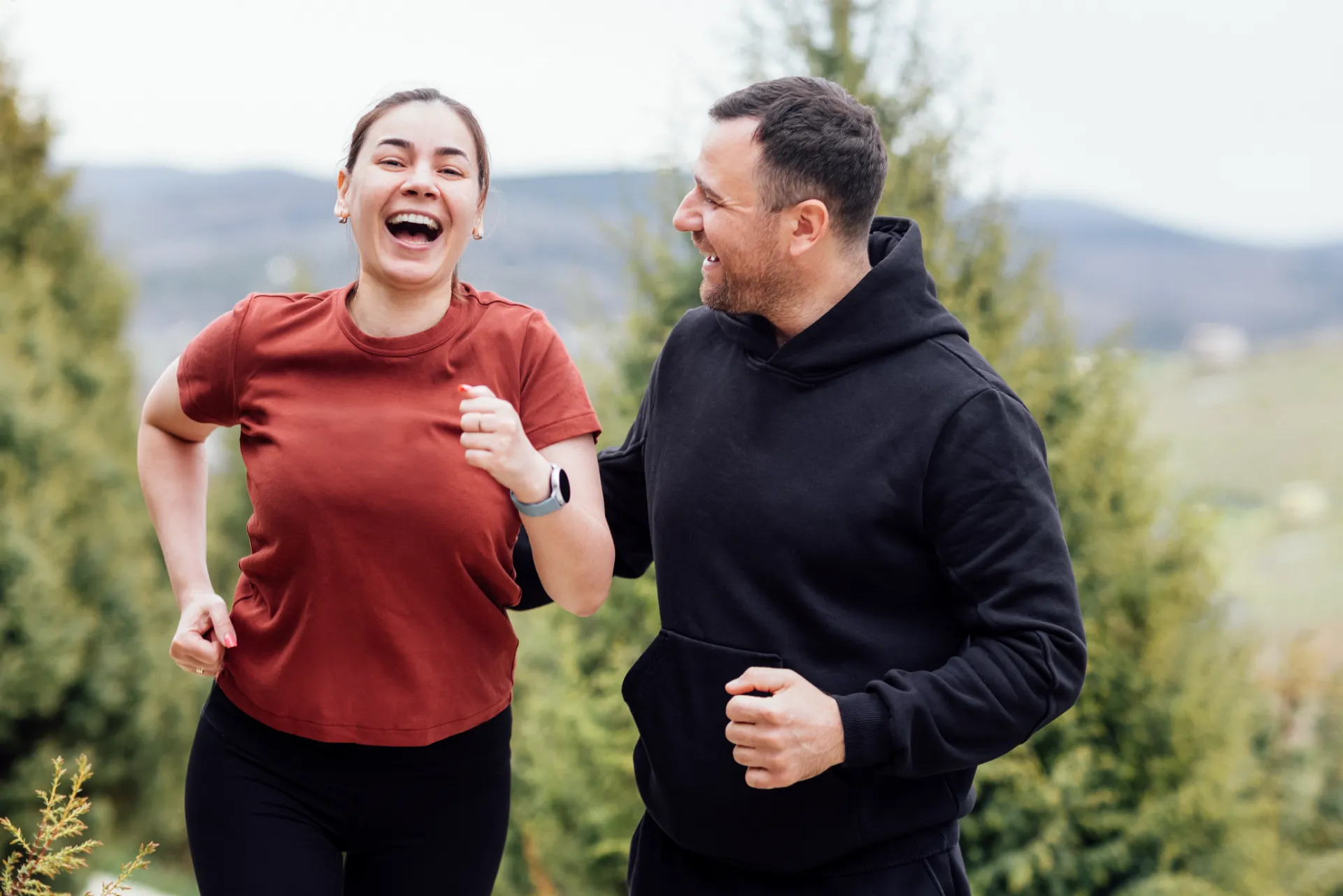 smiling attractive woman and handsome man jogging utc
