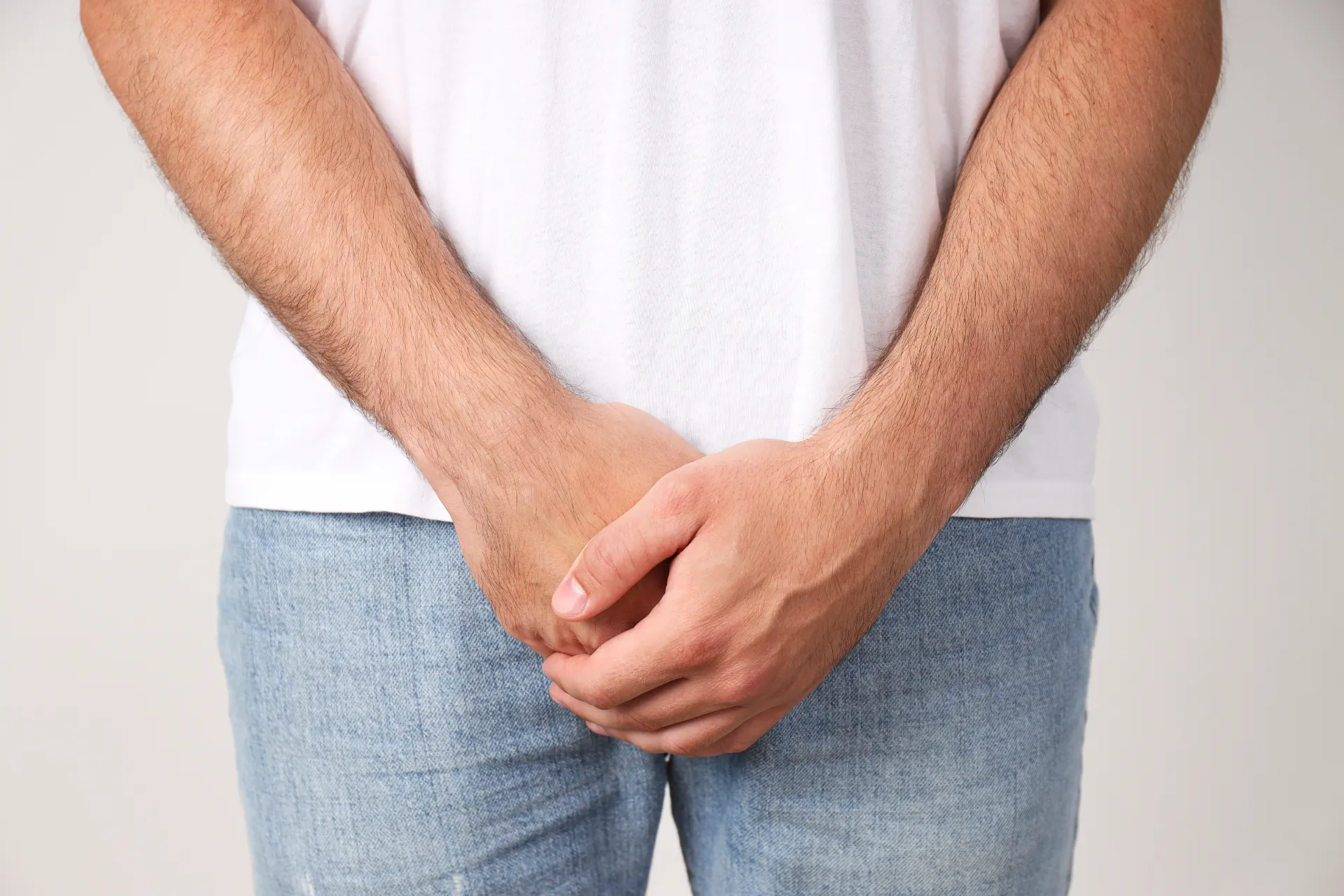 man holding groin with hands movember concept utc